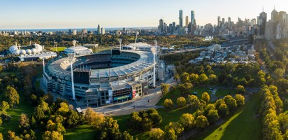 aerial photo of Melbourne Cricket Ground (MCG) with Melbourne skyline in background public holiday afl